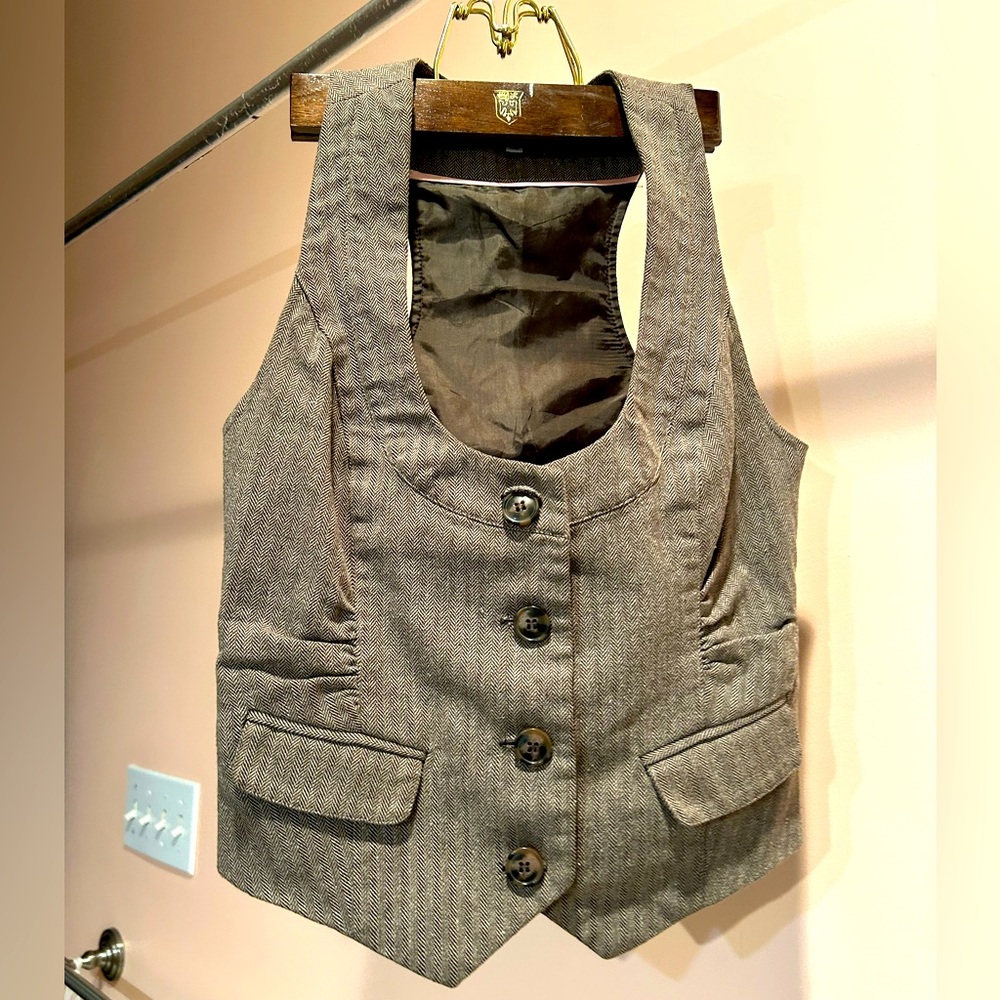 brown/beige LOW CUT vest. stylish and has lace on the back. perfect for layering